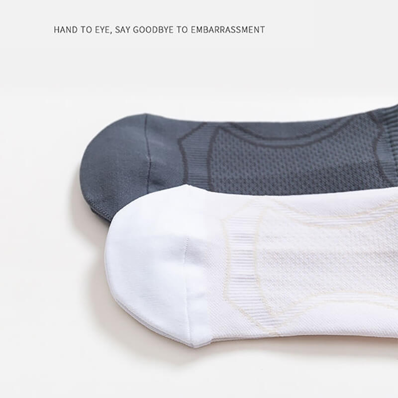 Close-up of anti-sweat unisex sport socks, black and white, showcasing breathable fabric. Ideal for running and fitness enthusiasts.